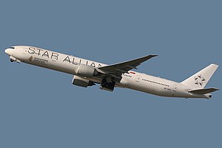 A Singapore Airlines Boeing 777-300ER in Star Alliance livery (with tail painted in white).