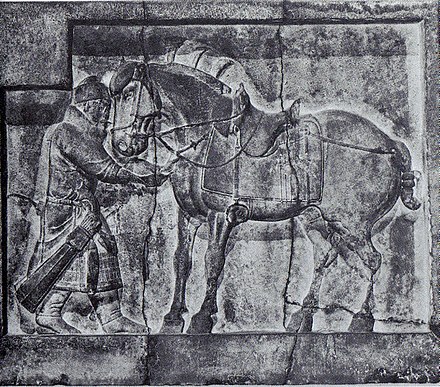 A bas relief of a soldier and the emperor's horse, Autumn Dew, with elaborate saddle and stirrups, designed by Yan Liben, from the tomb of Emperor Taizong c. 650