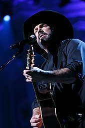 The Chase by Garth Brooks (picture) kept Erotica from the Billboard 200's first spot. Garth Brooks (49627465292).jpg