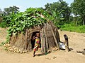 Girl running out of her hut