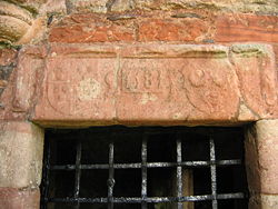 Inscription above the door. IS for James Seton, IE for Janet Edmonstone, his wife, with their respective coats of arms, and the date 1581. Greenknowe Tower Door.jpg