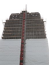 View of the lift and hoist system installed on the east face of the tower to remove debris from the tower Grenfell Tower in May 2018 07.jpg