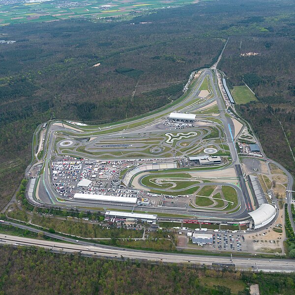 Aerial view of the track in 2023 with remains of the old track layout visible in the forest (upper left)