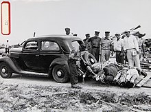 Collection of hurricane victims Hurricane victims towed on sled behind car, circa Sept. 5, 1935.jpg