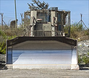 IDF D9R/T parking near a military outpost (front view)