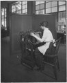 Intaglio web perforating machine for stamps. (Woman working) - NARA - 532293.tif