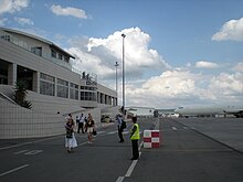 Airside exterior showing passengers exiting the terminal LanseriaAirport AirsideExterior Jan2009.jpg