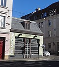 Commercial building (drugstore building) in semi-open development in a corner