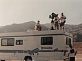 Making of ILLUSION INFINITY, director Roger Steinmann, sitting, with crew filming in Death Valley.jpg