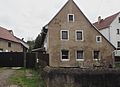 Farmhouse and courtyard wall (up to No. 25)