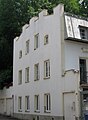 Two-storey residential building with a battlemented gable