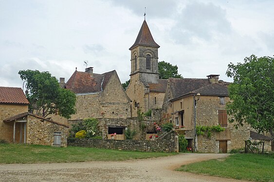 Older village buildings with colorful flowers, Perigord, France