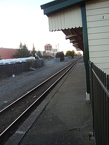 Station platform with Sanitarium factory and Langdons Road level crossing in the background