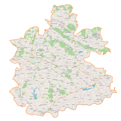 Mapa konturowa powiatu buskiego, po lewej znajduje się punkt z opisem „Busko-Zdrój”