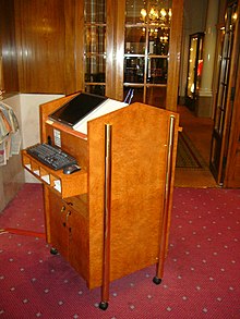 Hotels and restaurants use computerized reservations systems to manage demand and supply. Reception desk with a computer at a restaurant.JPG