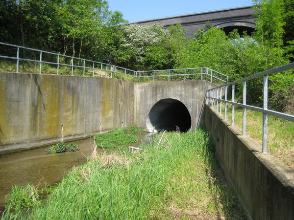 River Misbourne was diverted via culverts under M25 motorway. This is the downstream portal of the culvert. The railway viaduct is visible over the tr