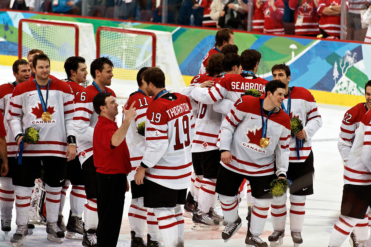 Team Canada captain Scott Niedermayer skates with the flag after