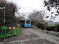 Southern Vectis 204 Woody Point (S603 KUT), a Toyota BB50R/Caetano Optimo IV, in Rew Lane, Wroxall, Isle of Wight. At the time, Newport Road between Wroxall and Ventnor had been closed for roadworks, meaning bus route 3 had to divert via Whitwell. To maintain a service to Wroxall, a shuttle service was run through Rew Lane linking the town with Ventnor. Rew Lane was closed to through traffic to keep the road clear for buses, so presumably the car behind was a resident on Rew Lane.