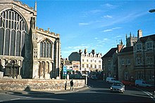 All Saints' Church, Stamford with the wooden war memorial, and Red Lion Square to the right Stamford Lincs.jpg