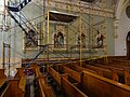 Stations of the cross XI through XIV in Saint Patrick Church behind scaffolding. (The scaffolding is for repair work being done on the stained glass window above these stations.) Located at 284 Suffolk Street, Lowell, Massachusetts.