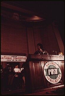 Jesse Jackson speaks at 1973 PUSH National Convention THE REV. JESSE JACKSON SPEAKS ON A RADIO BROADCAST FROM THE HEADQUARTERS OF OPERATION PUSH AT ITS ANNUAL CONVENTION.... - NARA - 556253.jpg