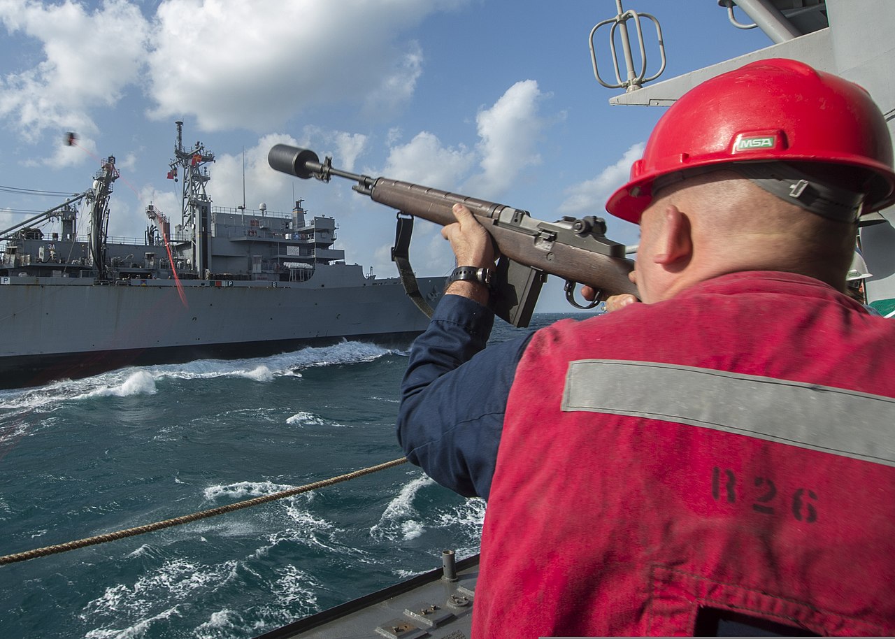 File U S Navy Gunner S Mate 2nd Class Nickolas Graham Uses An M14 Rifle To Fire A Shot Line From The Guided Missile Cruiser Uss San Jacinto Cg 56 To The Fast Combat Support