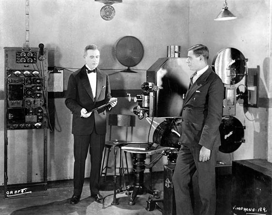Western Electric engineer E. B. Craft, at left, demonstrating the Vitaphone projection system. A Vitaphone disc had a running time of about 11 minutes, enough to match that of a 1,000-foot (300 m) reel of 35 mm film.