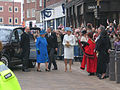 Prince Philip holding the door for Queen Elizabeth II, walking towards the provost