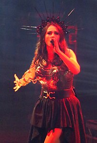 Composition for the album spanned a few years. Some tracks were conceived before the COVID-19 pandemic with the intention of promoting the Worlds Collide Tour, originally scheduled for 2020. In the picture, Sharon den Adel can be seen performing during the tour, which happened in 2022. Within Temptation live at the O2 LOndon - 52503186837.jpg