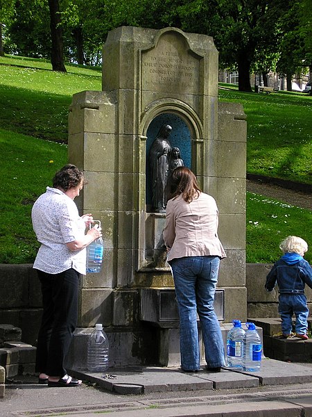 People filling bottles with water at St Ann's Well