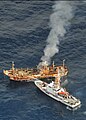 USCGC Anacapa sinks derelict Ryou-Un Maru fishing vessel with fire hose, 5 April 2012.