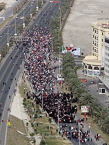 Thousands of protesters denouncing the Saudi intervention in a march to the Saudi embassy in Manama on 15 March 2011 Bahraini uprising - March (152).jpg