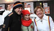 Mittermaier (re.) mit ihrem Mann Christian Neureuther (li.) und der Eiskunstläuferin Aljona Savchenko bei der Einkleidung der deutschen Olympiamannschaft 2018