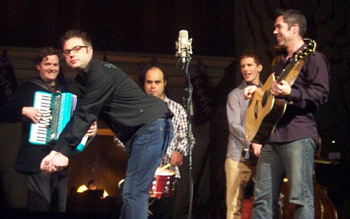 From left to right: Hearn, Stewart, Creeggan, and Robertson watch Page mime golfing during an ad lib in 2004.