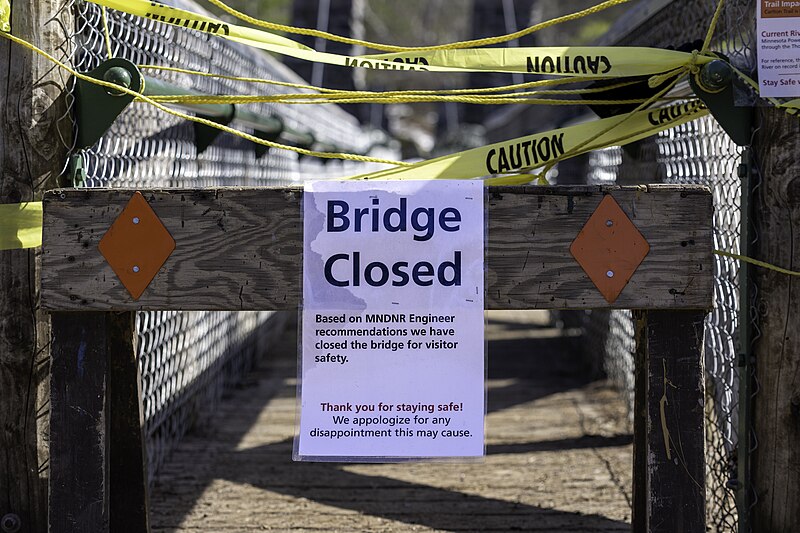 File:Bridge Closed sign at the swinging bridge at Jay Cooke State park and the flooded St Louis River in Carlton, Minnesota - 52828888942.jpg
