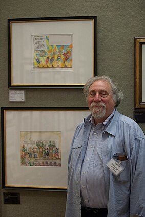 Degen poses in front of two of his artworks on display in the Mazza Museum. Bruce Degen with some of his work in the Mazza Museum.jpg