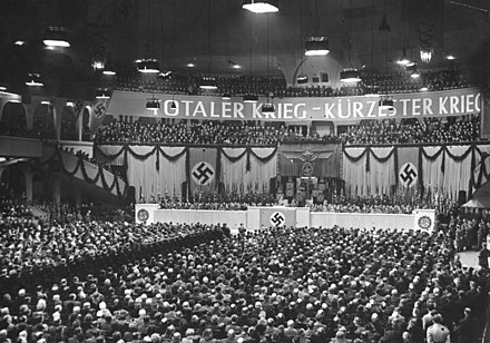 Nazi rally on 18 February 1943 at the Berlin Sportpalast; the sign says "Totaler Krieg – Kürzester Krieg" ("Total War – Shortest War").