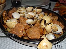 Carne de porco a alentejana is one of the most traditional and popular pork dishes of Portuguese cuisine Carne de porco a Alentejana.jpg