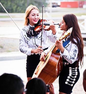 Julie and Jessica Castillo play instruments for Troopers and civilians.