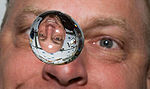 Astronaut Clayton Anderson watches as a water bubble floats in space shuttle Discovery