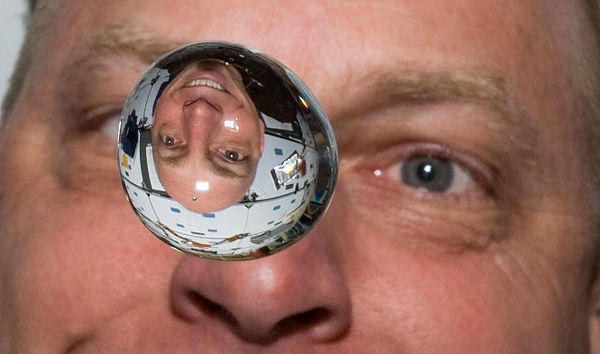 Anderson watches as a water bubble floats in front of him on the Space Shuttle Discovery during the STS-131 mission.