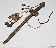 A Chinese coin sword-shaped talisman made from Qing dynasty era cash coins on display at the Museum of Ethnography, Sweden. Coin Sword.jpg