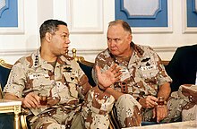 Schwarzkopf talks with General Colin Powell, Chairman of the Joint Chiefs of Staff, during a press conference regarding the Gulf War.