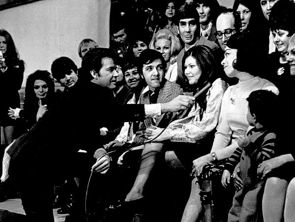 Dick Clark talks to Myrna Horowitz, one of the original dancers when the program began in 1952, on the show's 18th anniversary in 1970.