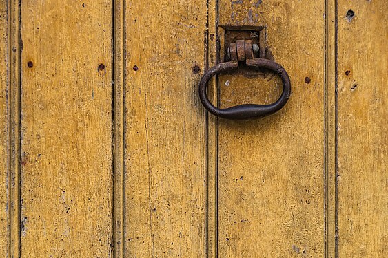 Door knocker of the building at Rue du College in Estaing, Aveyron, France