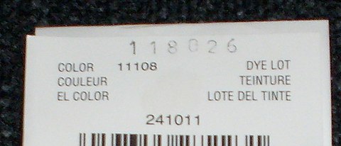A dye lot marking from a yarn label. The dye lot is the large stamped number at top. Other information such as color code has been preprinted in smaller digits. Dye lot.jpg