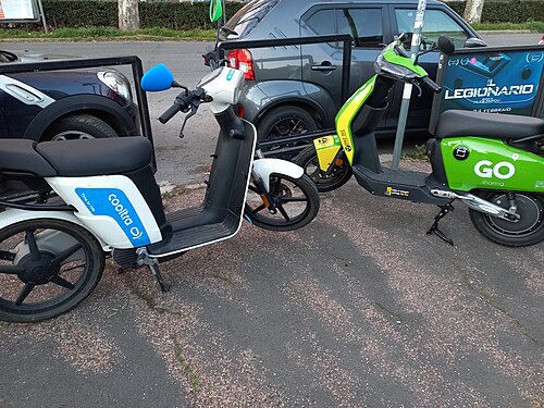 E-cooltra scooter and Go sharing scooter in the same frame in Rome