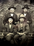 Thumbnail for File:Emmett Dalton and Jesse James standing Jesse Evans and Frank James seated.webp