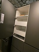 frameless high cabinet with shelves and drawers behind a door