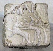Fighting scene between a beast and a man with horns, hooves and a tail, who has been compared to the Mesopotamian bull-man Enkidu.[24][27][26] Indus Valley civilization seal.